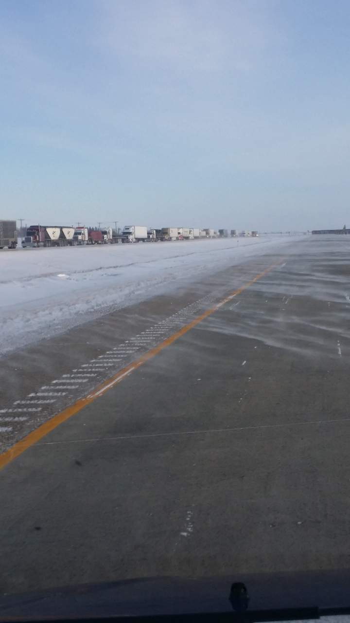 Trucks line up along U.S. Interstate 29 as it reopens on Tuesday morning.