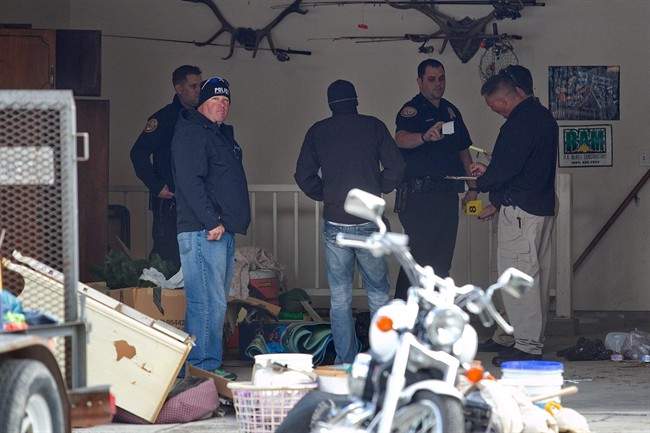 Authorities investigate a crime scene at a house in Pleasant Grove, Utah, Sunday, April 13, 2014.