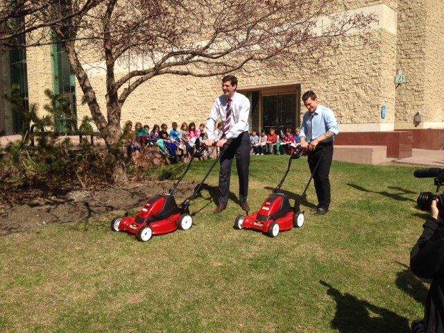 Campaign encourages Edmontonians to leave grass clippings on their lawns. Mayor and Edmonton Oilers captain do the mowing outside City Hall, May 12, 2014. 