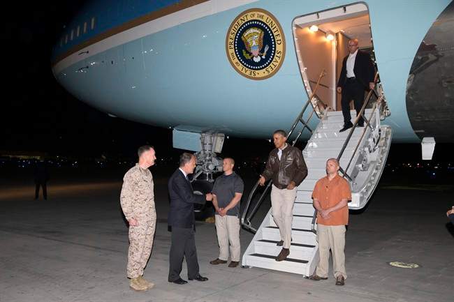 U.S. President Barack Obama is greeted by U.S. Ambassador to Afghanistan James Cunningham, second from left, and Marine General Joseph Dunford, commander of the U.S.-led International Security Assistance Force (ISAF), left, as he steps off Air Force One after arriving at Bagram Air Field for an unannounced visit, on Sunday, May 25, 2014.