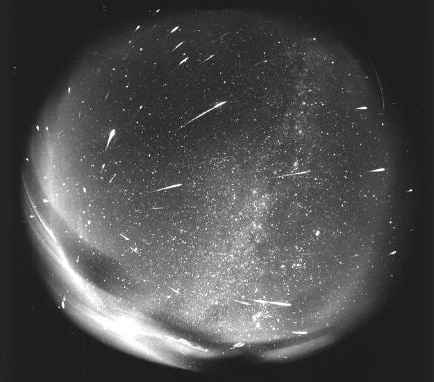 An all-sky camera captures a image of meteors over time.