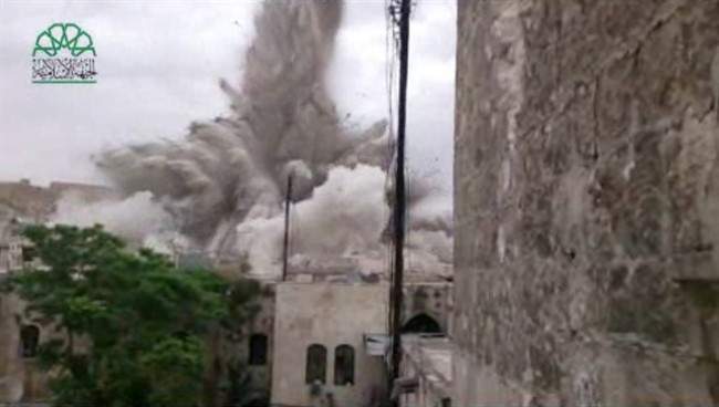 This image made from amateur video posted by Shaam News Network (SNN), an anti-Bashar Assad activist group, which has been verified and is consistent with other AP reporting, shows an explosion that destroyed the Carlton Hotel in Aleppo, Syria, Thursday, May 8, 2014. 