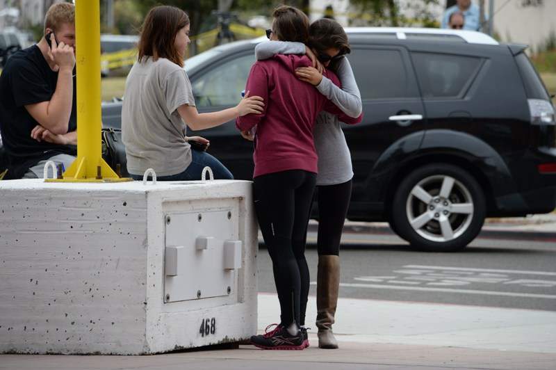 Students hug on May 24, 2014, after a drive-by shooting in Isla Vista, California, a beach community next to the University of California Santa Barbara.