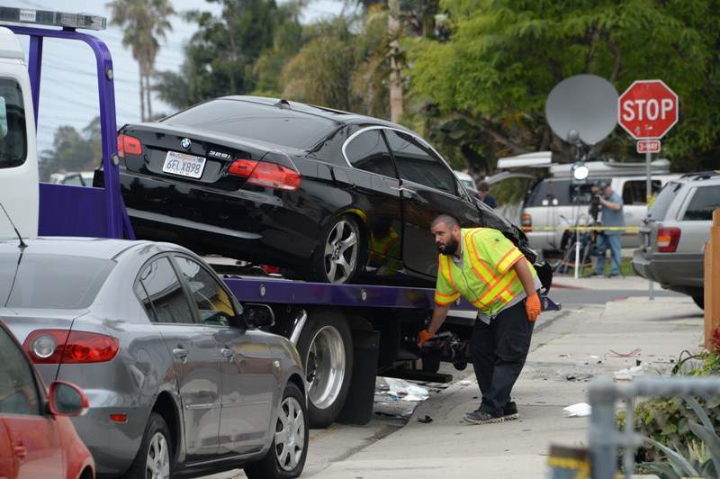 A suspected gunman’s car is removed from a crash sitr on May 24, 2014, after a drive-by shooting in Isla Vista, California, a beach community next to the University of California Santa Barbara.