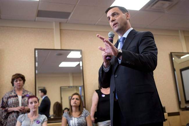 Ontario PC Leader Tim Hudak holds a town hall meeting in a hair salon in Pickering, Ontario on Tuesday May 27 , 2014, as he continues his election campaign. THE CANADIAN PRESS/Chris Young.