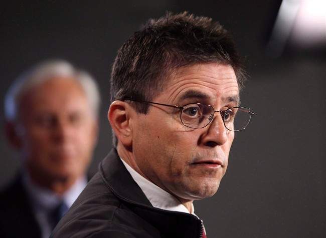 Hassan Diab speaks at a press conference while his lawyer, Donald Bayne, listens on Parliament Hill in Ottawa on Friday, April 13, 2012.