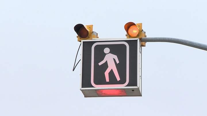 FILE - A crosswalk light.