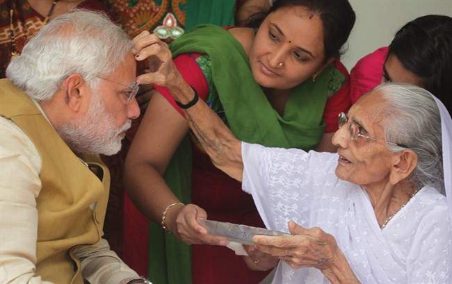 90-year-old Hiraben marks the forehead of her son and India’s next prime minister Narendra Modi with vermillion as a sign of blessing in Gandhinagar, in the western Indian state of Gujarat, Friday, May 16, 2014.