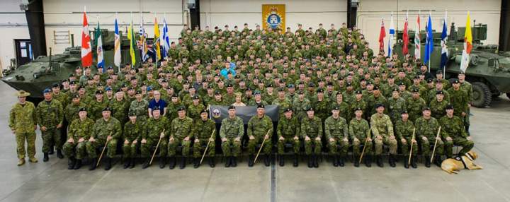 Courageous Companions service dog Hank, pictured with Cpl. Johnny Langevin and his regiment.