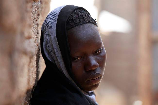 In this photo taken Monday, May 19, 2014, Solome Ishaya, sister of kidnapped school girls Hauwa Ishaya stands outside their family house in Chibok, Nigeria.