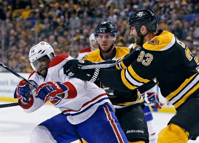 Boston Bruins defenseman Zdeno Chara (33) tries to move Montreal Canadiens defenseman P.K. Subban (76) off the puck as Bruins center David Krejci, middle, looks on during the second period in Game 2 of an NHL hockey second-round playoff series in Boston, Saturday, May 3, 2014. 