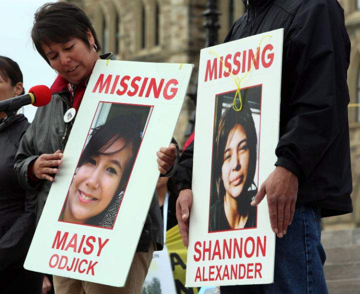 Laurie Odjick holds a sign with photo of her missing daughter, Maisy, who went missing along with Shannon Alexander in 2008 at age 16. Odjick was taking part in a rally on Parliament Hill in Ottawa on Friday, October 4, 2013 by the Native Women's Assoiciation of Canada honouring the lives of missing and murdered Aboriginal women and girls.