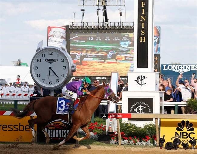 California Chrome, ridden by jockey Victor Espinoza, wins the 139th Preakness Stakes horse race at Pimlico Race Course, Saturday, May 17, 2014, in Baltimore.