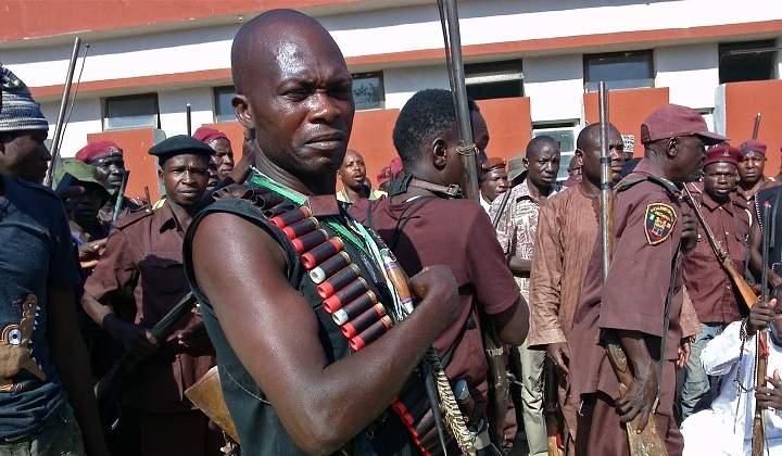 In this photo taken on, Sunday, May 18, 2014, armed hunters gather before looking for around 300 abducted school girls in Maiduguri, Nigeria. 