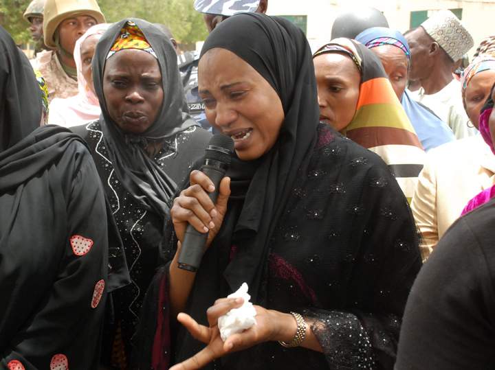 In this photo taken Monday, May 5, 2014, Nana Shettima weeps as she speaks with school girls from the government secondary school.