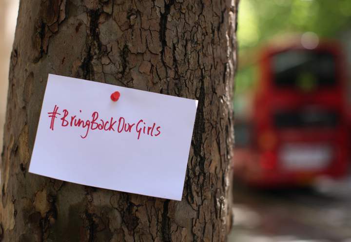 A sign that reads 'Bring back our girls' is pinned to a tree as Protesters calling for the release of a group of abducted Nigerian schoolgirls gather outside Nigeria House on May 9, 2014 in London, England. 