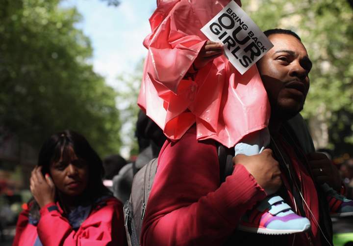Protesters calling for the release of a group of abducted Nigerian schoolgirls gather outside Nigeria House on May 9, 2014 in London, England.