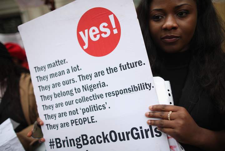A woman holds a placard during a protest calling for the release of 276 abducted Nigerian schoolgirls outside Nigeria House on May 9, 2014 in London, England.