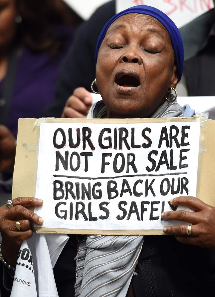 Protestors hold placards as they demonstrate outside Nigeria House in central London on May 9, 2014, to demand the return of more than 200 Nigerian schoolgirls abducted by the Boko Haram Islamist group.