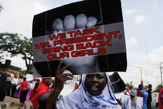 Women attend a mass demonstration calling on the government to increase efforts to rescue the hundreds of missing kidnapped school girls.