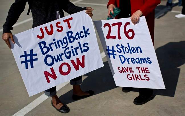 FILE - In a Thursday, May 8, 2014 file photo, South Africans protest in solidarity against the abduction three weeks ago of hundreds of schoolgirls in Nigeria by the Muslim extremist group Boko Haram and what protesters said was the failure of the Nigerian government and international community to rescue them, during a march to the Nigerian Consulate in Johannesburg, South Africa.