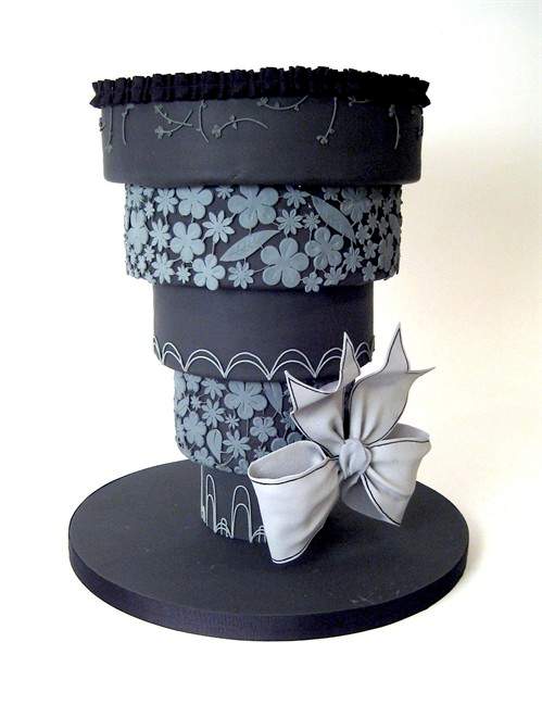 This undated image released by Charm City Cakes shows an upside-down wedding cake frosted in black, a divorce cake by celebrity chef and baker Duff Goldman from Charm City Cakes in Baltimore, Md.