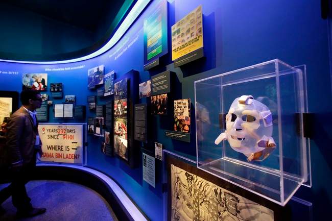 The burn mask, right, of a World Trade Center survivor who was injured by burning jet fuel, is displayed at the National Sept. 11 Memorial Museum, Wednesday, May 14, 2014, in New York.
