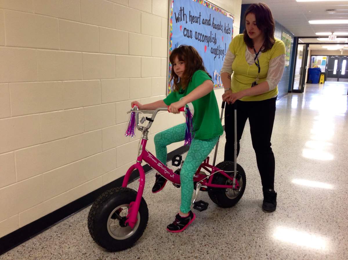 Arabella Keam has cerebral palsy and is learning how to ride a bike thanks to a modified bicycle. 