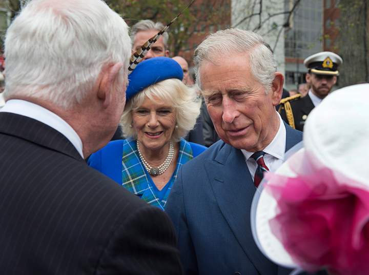 Prince Charles and his wife Camilla, the Duchess of Cornwall, chat with Governor General David Johnston at the Grand Parade in Halifax on Monday, May 19, 2014. The couple is on a four-day tour of Canada.