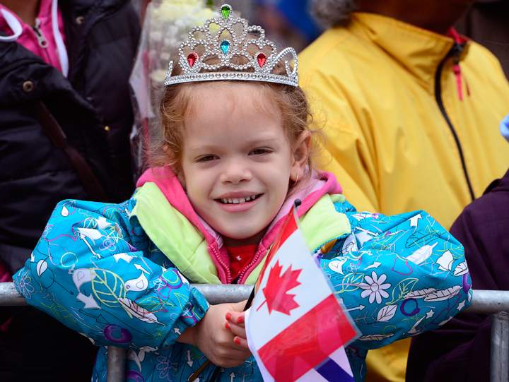 A girl waits for the arrival of Prince Charles and his wife Camilla in Halifax on Monday, May 19, 2014.