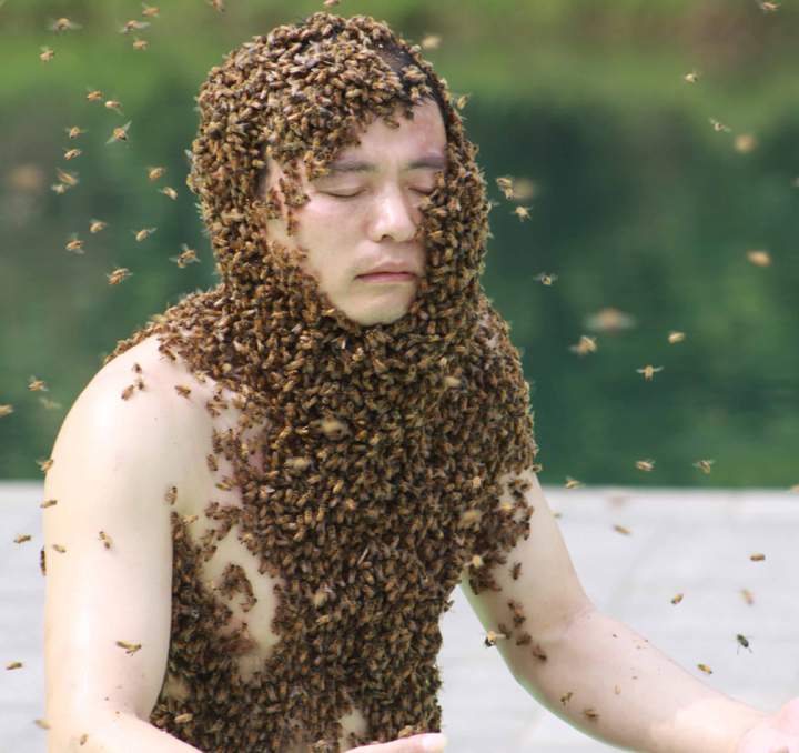 Ruan Liangming sets a Guinness World Record with sticking with bees covered on skin above shoulder for 53 minutes and 34 seconds on May 13 in Yichun, Jiangxi Province of China.