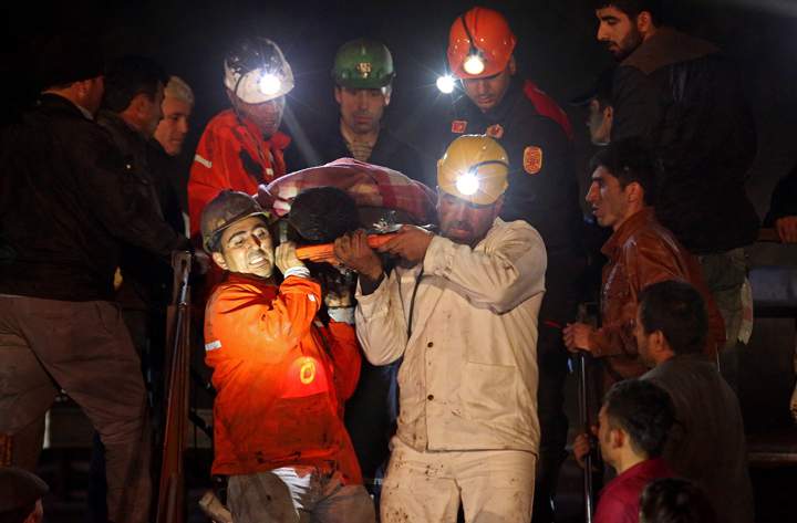 Miners are helped by rescue workers and friends from the coal mine.