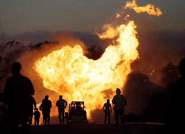 FILE - In this Sept. 9, 2010 file photo, a massive fire roars through a mostly residential neighborhood in San Bruno, Calif. A report released Friday by the Department of Transportation’s inspector general says the federal agency responsible for making sure states effectively oversee the safety of natural gas and other pipelines is falling down on the job. 