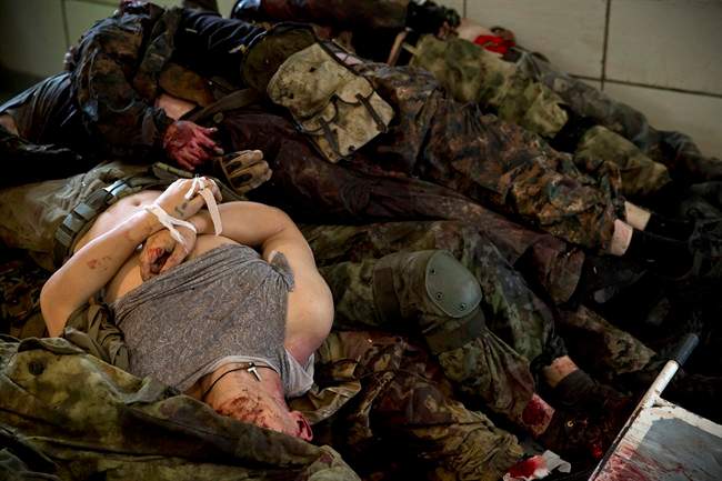 The bodies of pro-Russian gunmen killed in clashes with Ukrainian government forces around the airport are piled up at a city morgue in Donetsk, Ukraine, Tuesday, May 27, 2014. 