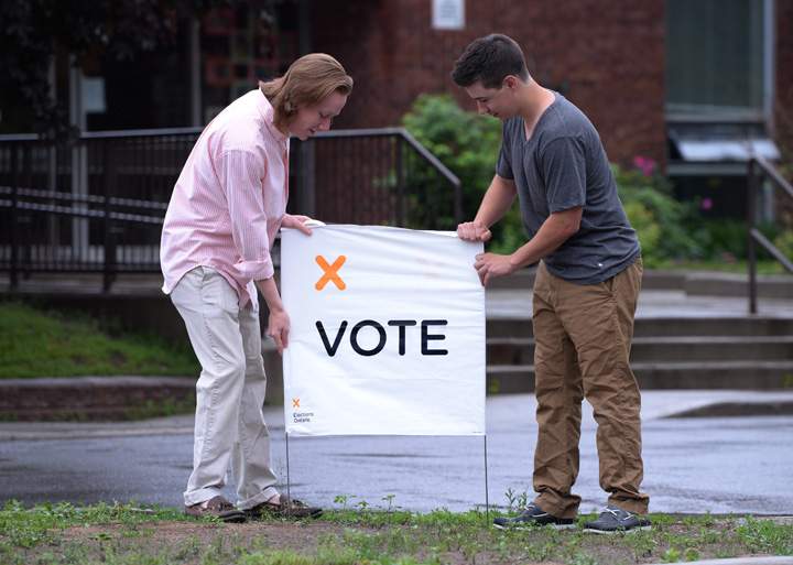 Election workers prepare to open a poll in Carleton Place, Ont. on Thursday June 12, 2014.