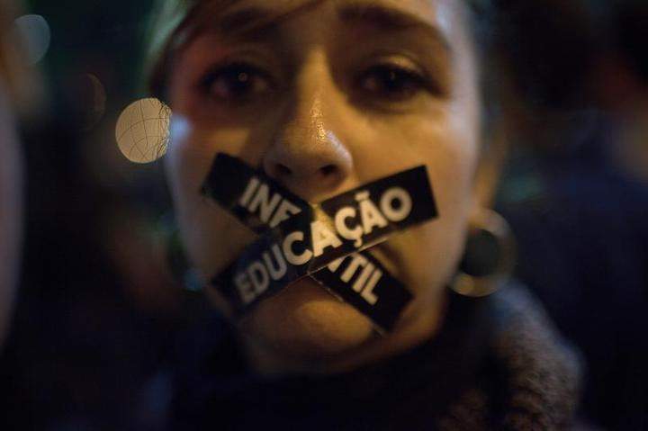 A teacher demonstrators protests against wage inequalities and government corruption in Rio de Janeiro on May 30. Protestors took to the streets demanding better public services and protesting the expense of hosting the World Cup.