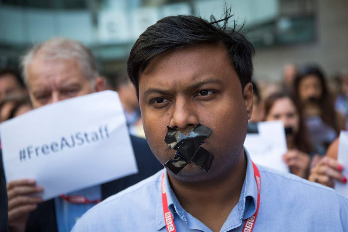 BBC staff and colleagues from other news organisations take part in a one-minute silent protest outside New Broadcasting House against the seven-year jail terms given to three al-Jazeera journalists in Egypt.