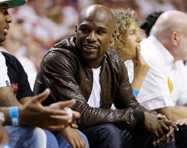 Boxer Floyd Mayweather Jr., seen here at the 2014 NBA Finals, met briefly with rival Manny Pacquiao at an NBA gam on Jan. 27, 2015.
