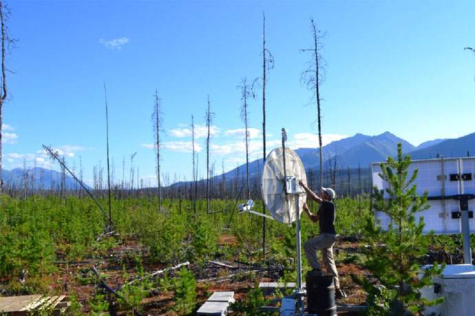 Pascal Audet installs a seismic station, similar to the one that monitors earthquakes in British Columbia, in the Yukon.