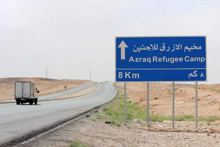 A road sign on the highway pointing to Azraq Refugee Camp