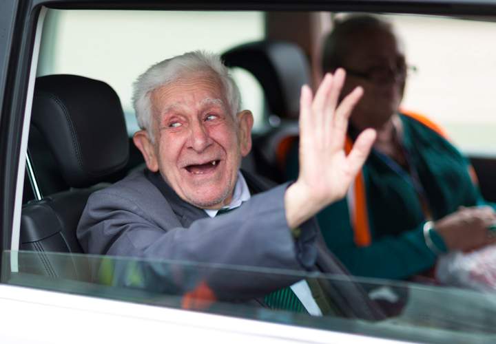 Bernard Jordan, the 90-year-old war veteran found in Normandy after being reported missing from his care home in Hove, Sussex, waves as he returns to Portsmouth on a Brittany Ferry.