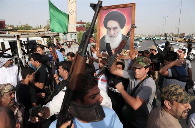 Iraqi Shiite tribal fighters raise their weapons and chant slogans against the al-Qaida-inspired Islamic State of Iraq and the Levant, after authorities urged Iraqis to help battle insurgents, in Baghdad's Sadr City, Iraq, Wednesday, June 18, 2014.