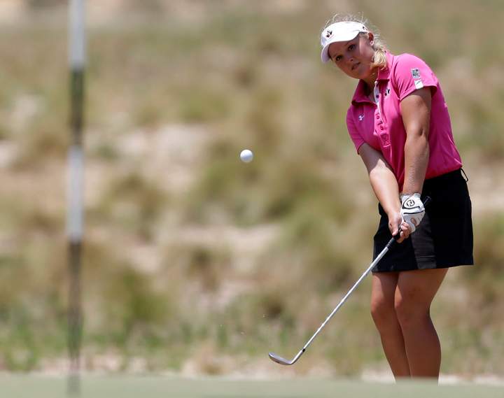 Brooke Henderson chips to the 12th hole during the first round of the U.S. Women's Open golf tournament in Pinehurst, N.C., Thursday, June 19, 2014. 