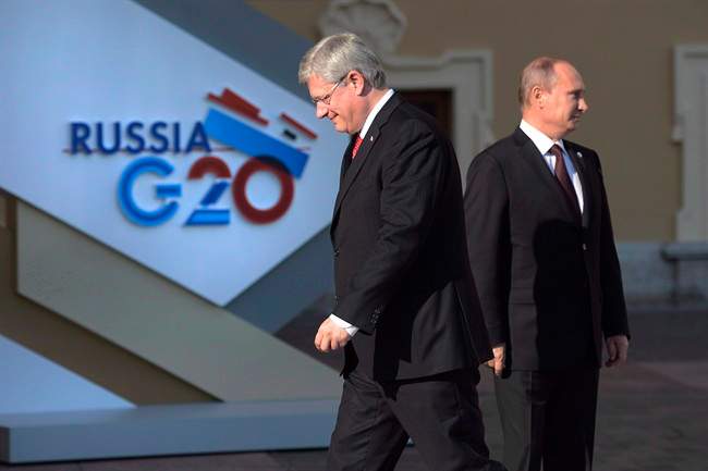 Minister Stephen Harper walks past Russian President Vladimir Putin at the G20 Summit Thursday Sept.5, 2013 in St.Petersburg, Russia.