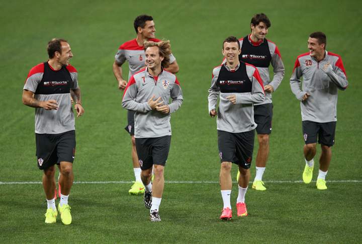 (Front L-R) Gordon Schildenfeld, Ivan Rakitic and Ivan Perisic of Croatia job during a Croatia Training session ahead of the 2014 FIFA World Cup Brazil opening match against Brazil at Arena de Sao Paulo on June 11, 2014 in Sao Paulo, Brazil.