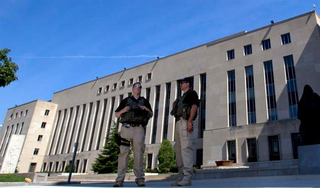 U.S. Marshalls guard the area outside of the federal U.S. District Court in Washington Saturday, June 28, 2014, after security was heightened in anticipation of a possible court appearance by captured Libyan militant Ahmed Abu Khattala later in the day. (AP Photo/Jose Luis Magana).