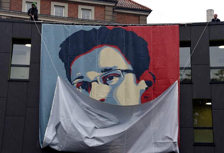 Students of the Muthesius Academy of Fine Arts and Design in Kiel uncoil a placard showing US intelligence leaker Edward Snowden as part of a campaign by German activists to grant asylum for Edward Snowden.
