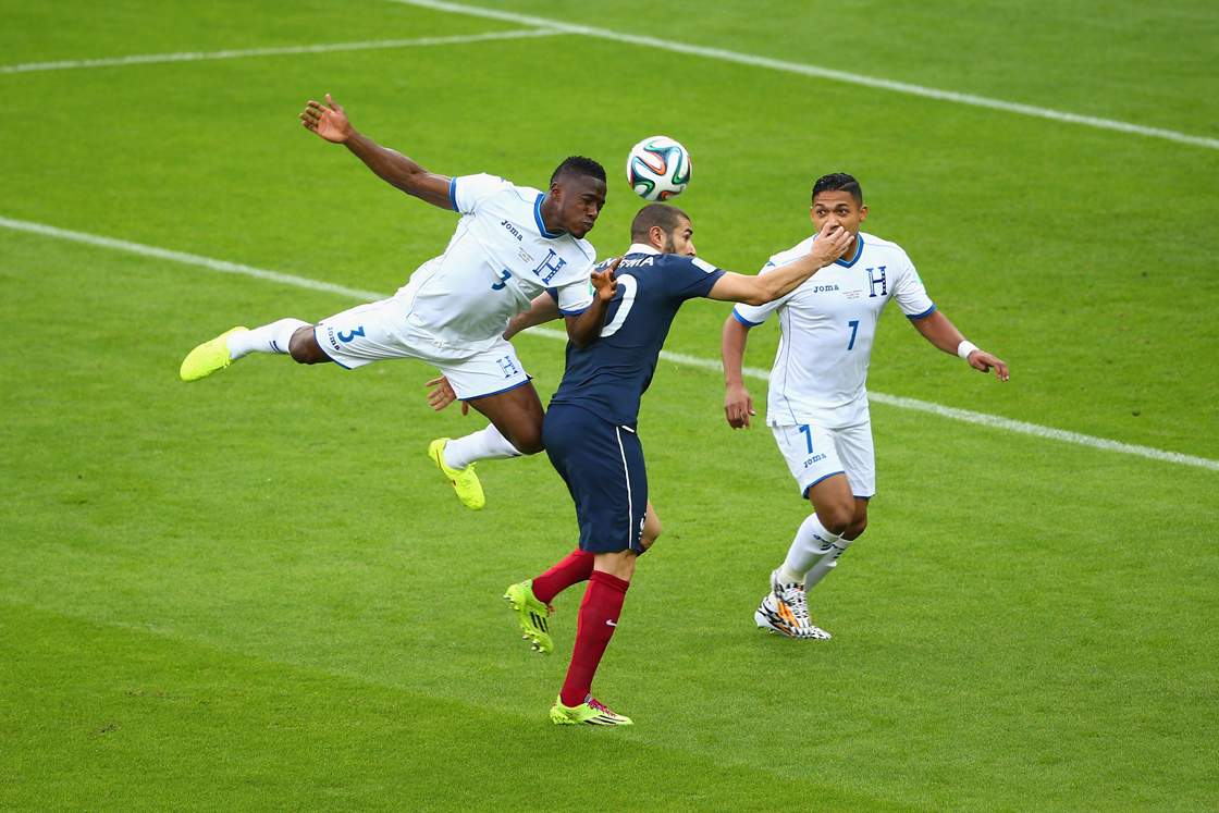 PORTO ALEGRE, BRAZIL - JUNE 15: Patrice Evra of France lies on the field as teammates Antoine Griezmann (2nd L) and Karim Benzema look on with referee Sandro Ricci during the 2014 FIFA World Cup Brazil Group E match between France and Honduras at Estadio Beira-Rio on June 15, 2014 in Porto Alegre, Brazil. (Photo by Paul Gilham/Getty Images)