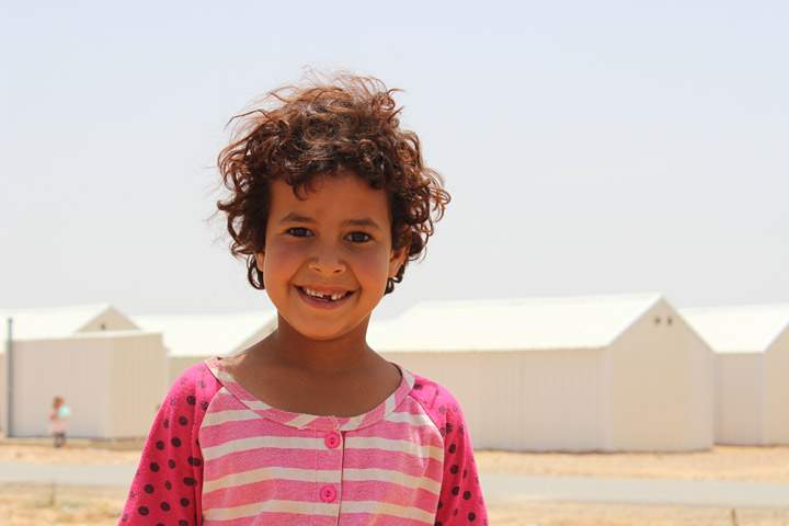 A Syrian girl poses for a picture in Azraq