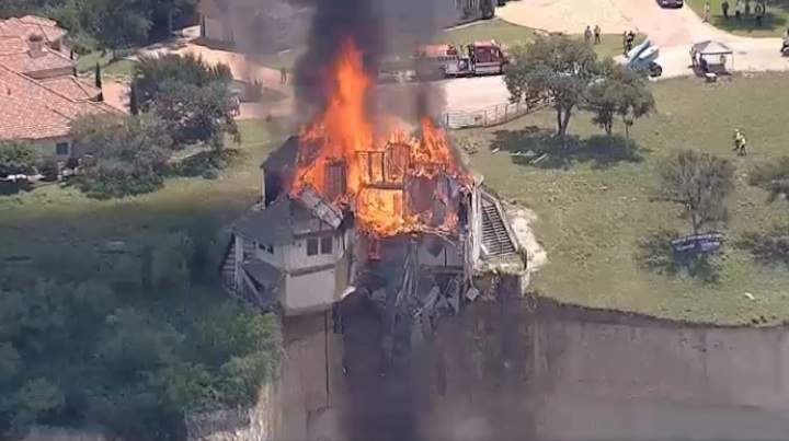 A house in Lake Whitney, Texas close to falling off the cliff it sits on was set on fire Friday afternoon.